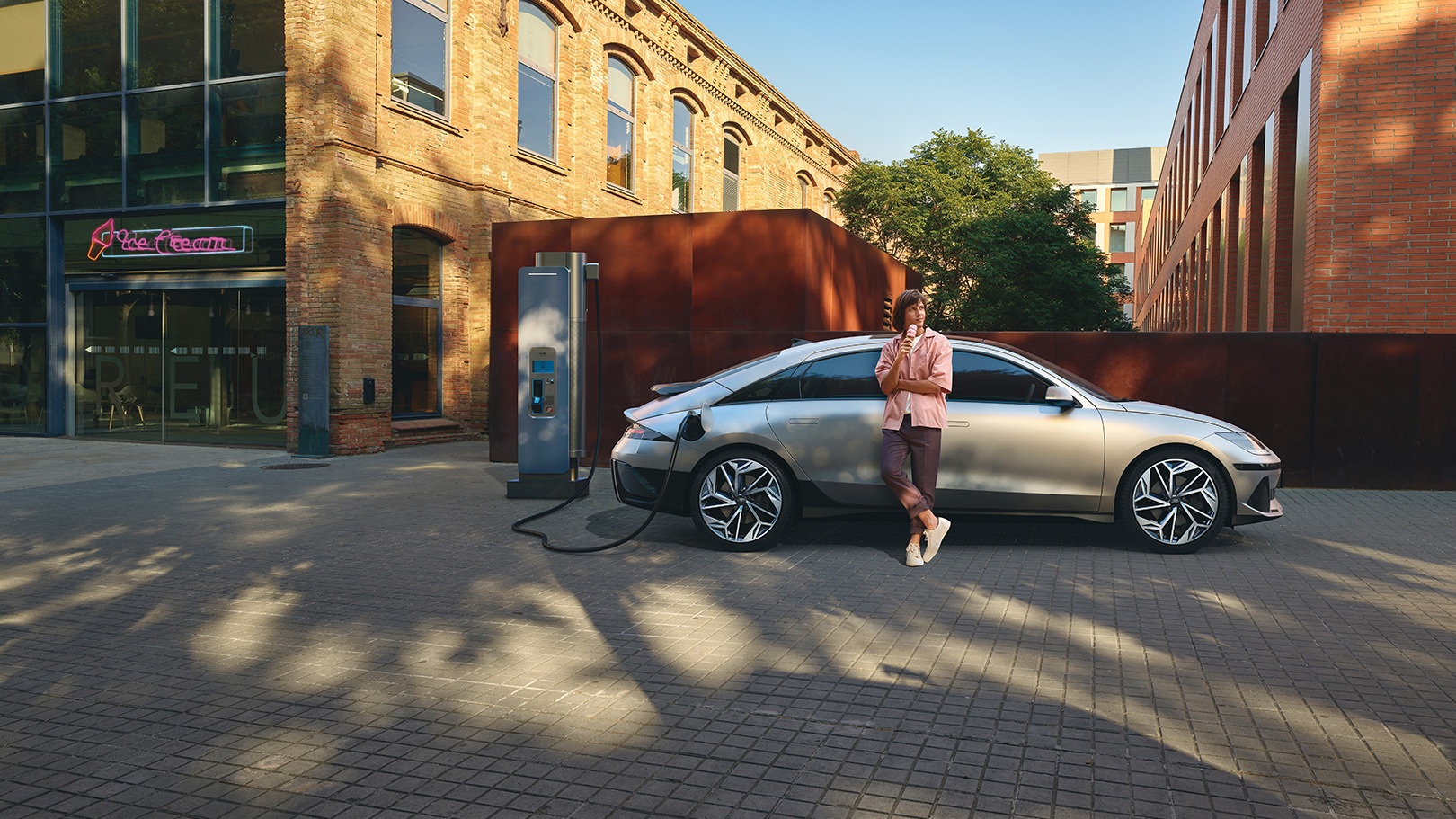man eating ice cream leaning on right side of IONIQ 6